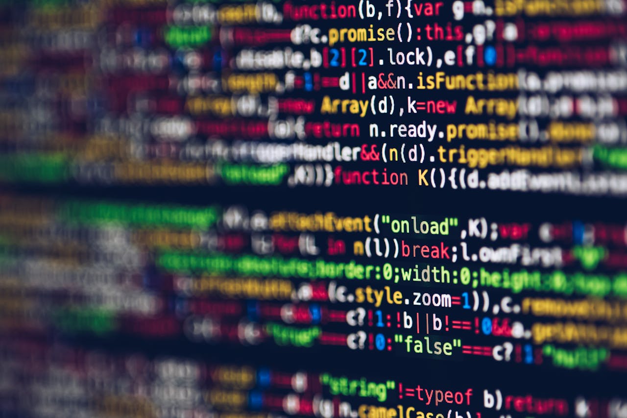services-04 Vivid, blurred close-up of colorful code on a screen, representing web development and programming.