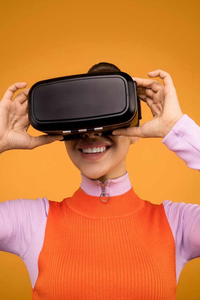 services-03 Smiling woman wearing VR headset on vibrant orange background.