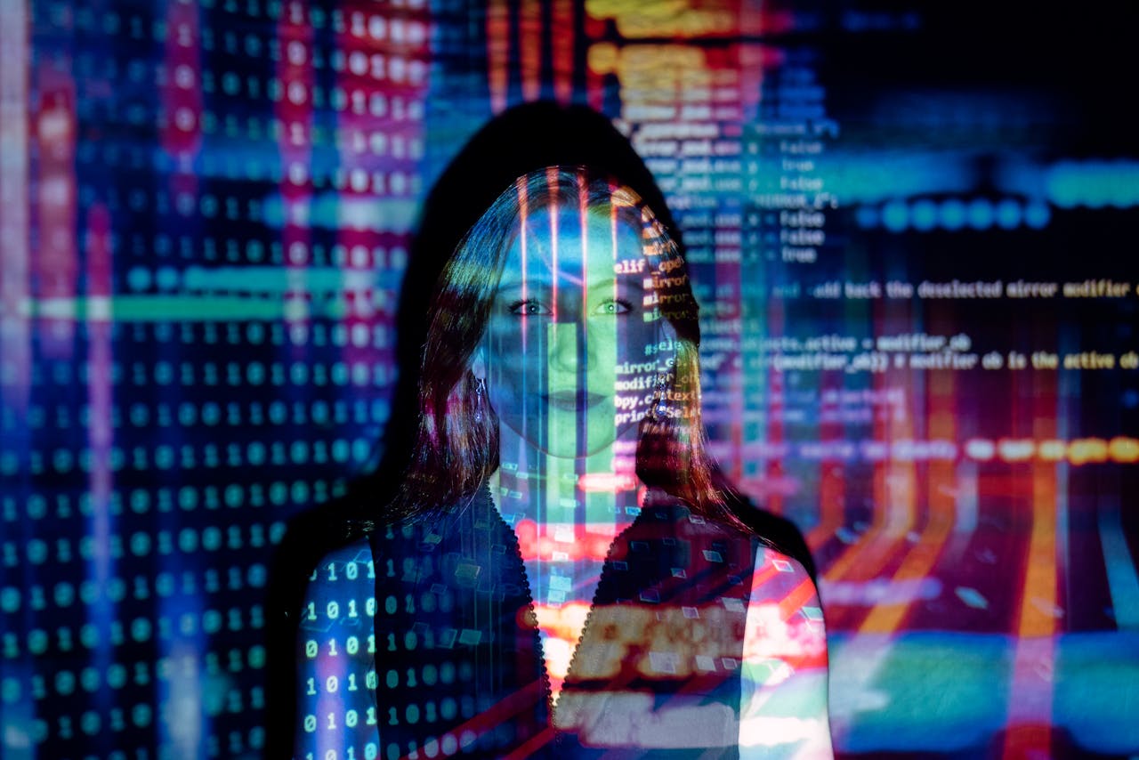 about-us A woman with digital code projections on her face, representing technology and future concepts.