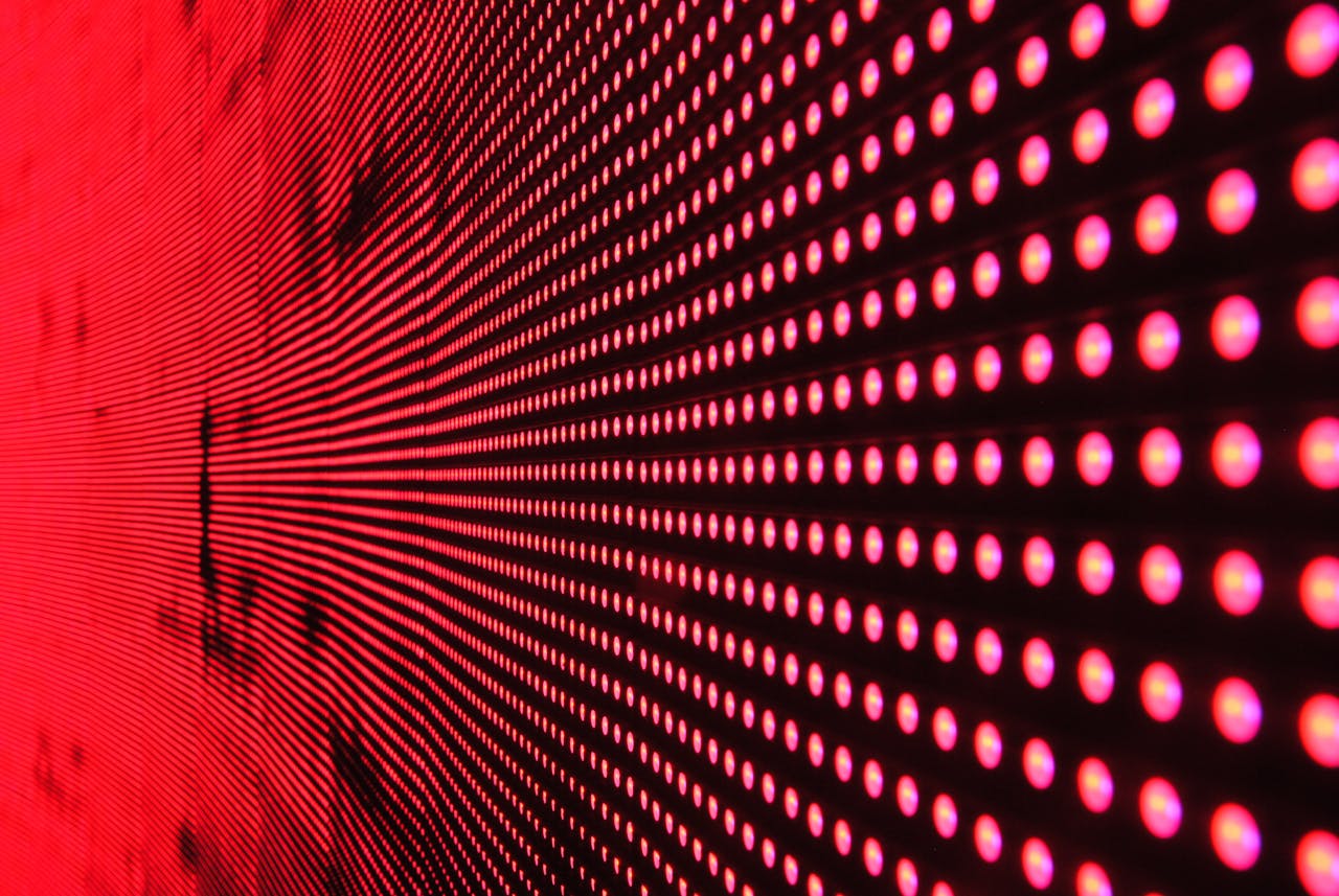 services-05 Vibrant abstract pattern of illuminated red LED lights forming a dynamic design.